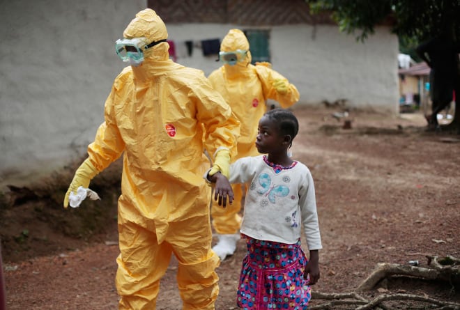 Nine-year-old Nowa Paye is taken to an ambulance after showing signs of the Ebola infection in the village of Freeman Reserve, about 30 miles north of Monrovia, Liberia. 